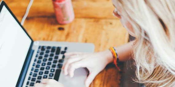 Woman Typing on Laptop